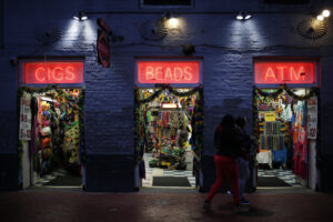 Pedestrians walk past a gift shop on Bourbon Street in the French Quarter of New Orleans. MUST CREDIT: Luke Sharrett/Bloomberg