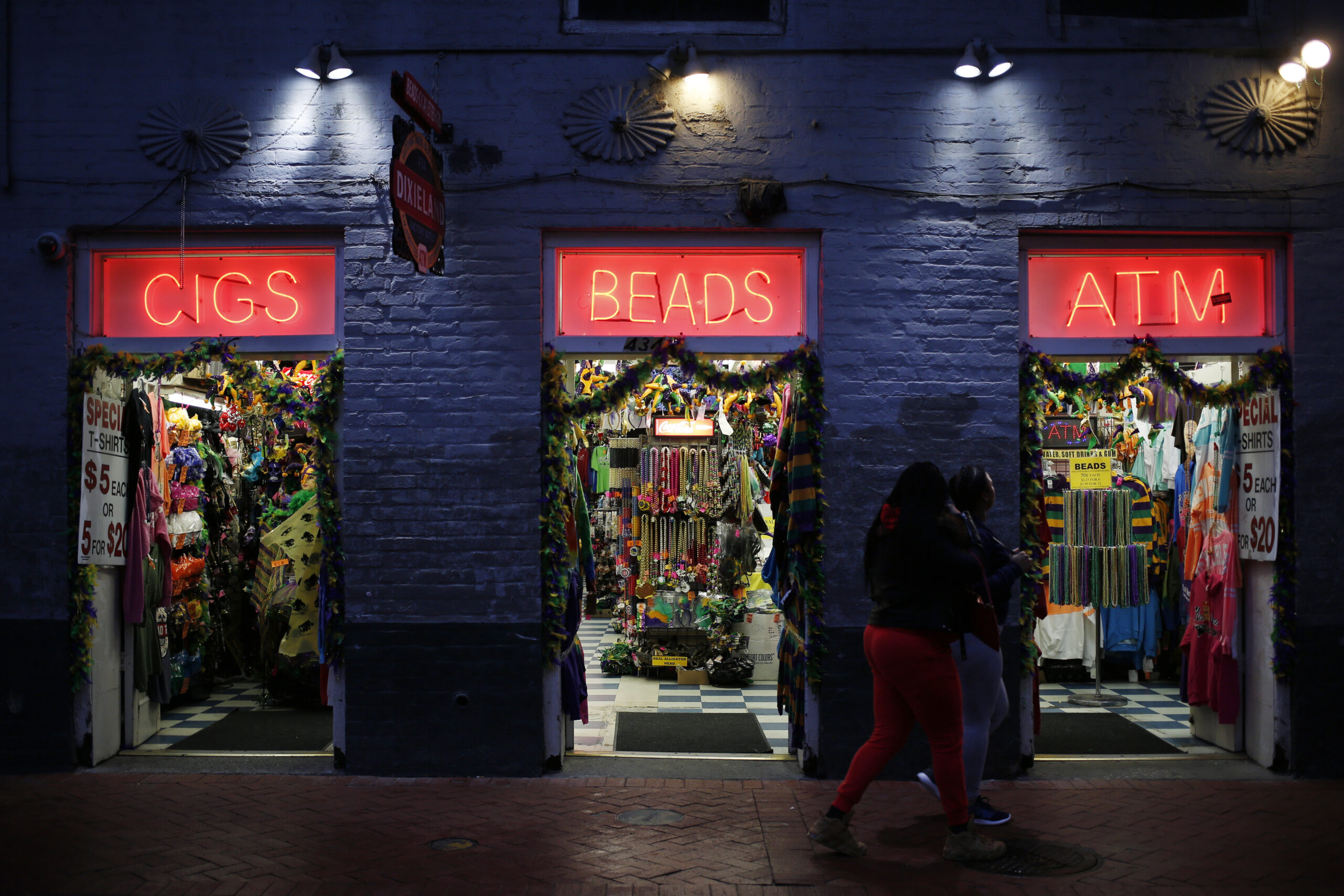 Pedestrians walk past a gift shop on Bourbon Street in the French Quarter of New Orleans. MUST CREDIT: Luke Sharrett/Bloomberg